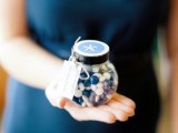 a jar with navy and white candies and a starfish sticker on top is a great idea for a beach, nautical or coastal wedding