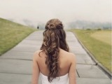 a simple and chic half updo with twists and a top knot plus curls down is a cool idea for long hair