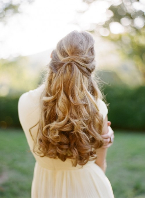 an elegant and refined wavy half updo with twists and a lot of volume is a gorgeous idea for any bride with long hair