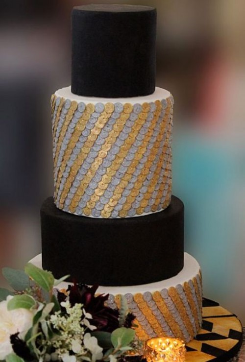 a bold and contrasting wedding cake with matte black tiers and gold and silver scllops is a stylish and bold idea for an art deco wedding