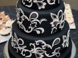 a chic and refined black wedding cake with black and white sugar patterns is a lovely idea for a sophisticated vintage wedding