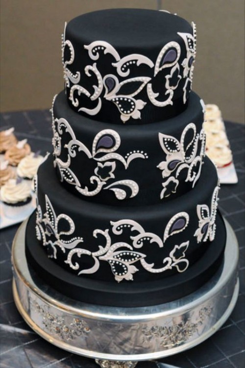 a chic and refined black wedding cake with black and white sugar patterns is a lovely idea for a sophisticated vintage wedding