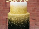 a beautiful and shiny wedding cake with an ombre white to gold glitter and black look, with a gold calligraphy topper is a gorgeous idea to try