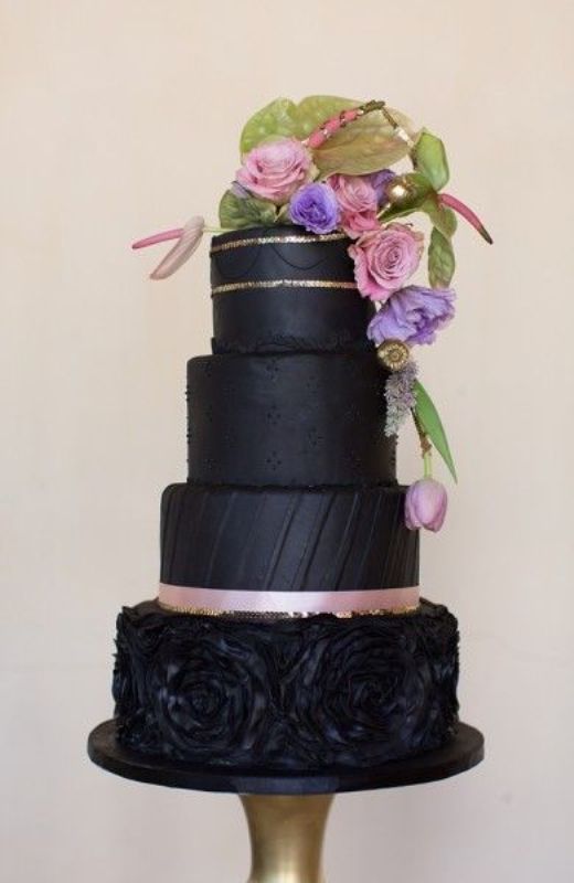 A catchy and chic black wedding cake with plain or textural tiers, gold glitter and pink ribbons, pastel blooms and greenery is a lovely idea for a dark romance and vintage inspired wedding