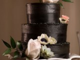 a dark chocolate wedding cake with ribbon, with white and pastel blooms and greenery is a stylish and elegant idea for a modern wedding