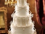 a white wedding cake with patterns, beads, rhinestones, crystals looks very refined and very chic