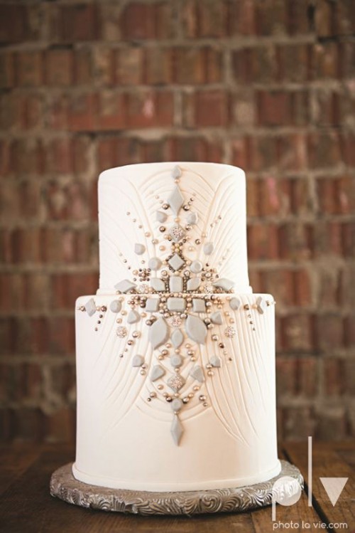 a textural white wedding cake decorated with matte and shiny beads looks really chic and beautiful