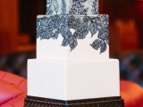 a black and white wedding cake with black lace decor is vintage-inspired, yet chic and refined