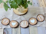 a wood slice garland with a wedding date and hearts is a lovely rustic decoration for your wedding, DIY some yourself
