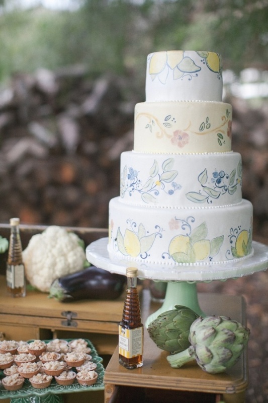 a neutral wedding cake with painted tiers   fruit, berry and floral ones done in pastel shades is a very cute and lovely idea for a spring or summer wedding