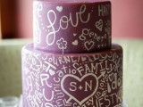 a burgundy wedding cake with white calligraphy and hearts painted on it looks very nice and very personalized and will easily fit any not too formal edding
