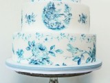 a white wedding cake with blue flowers painted and a romantic image will be a beautiful idea for a vintage-inspired wedding