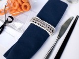 a glam pearl and bead napkin ring beautifully accents a navy napkin and it will add glam to your tablescape