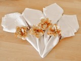 peachy fabric flower napkin rings are a beautiful and delicate accent to a spring or summer wedding tablescape