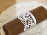a cardboard laser cut floral napkin ring is a pretty and chic idea for many kinds of weddings