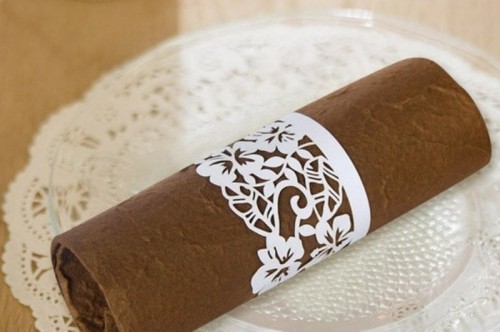 a cardboard laser cut floral napkin ring is a pretty and chic idea for many kinds of weddings