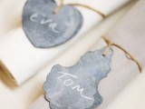 twine napkin rings with black chalkboard tags that act as place cards are amazing for a rustic wedding