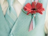 a mint green waistcoat plus a matching striped tie, a bold red boutonniere for a retro groom’s look