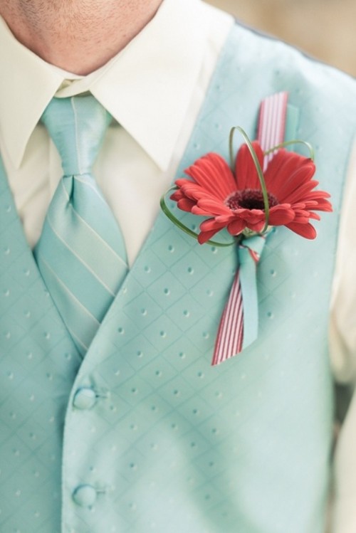 a mint green waistcoat plus a matching striped tie, a bold red boutonniere for a retro groom's look