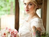 a vintage-inspired draped lace embellished wedding dress with cap sleeves that let us see the bride’s tattoo on the arm