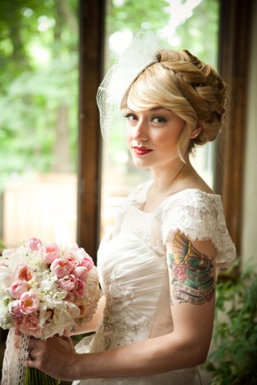 a vintage-inspired draped lace embellished wedding dress with cap sleeves that let us see the bride's tattoo on the arm
