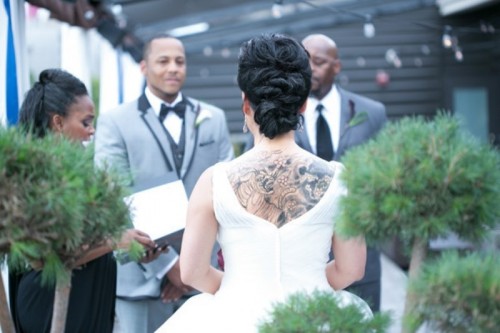 a pretty wedding ballgown with a cutout back that shows off the tattoo of the bride on the back