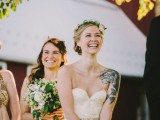a strapless draped wedding dress that shows off the shoulder tattoo of the bride at its best
