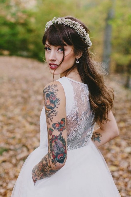 a strapless wedding ballgown with a lace back and no sleeves to show off bold and colorful bridal tattoos