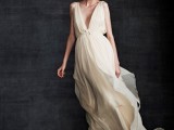 a very flowy Grecian wedding dress with a plunging neckline, an embellished sash and a long flowy train