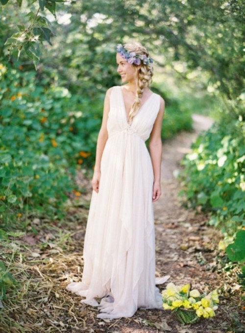 a draped Grecian wedding dress with a pleated skirt and a bodice with thick straps and a deep neckline