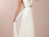 a Grecian pleated A-line wedding dress with a V-neckline, an open back, embellishments on the bodice, back and sleeves