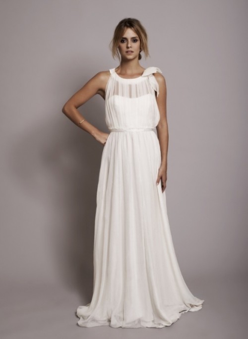 a draped A-line Grecian wedding dress with a sleeveless bodice, illusion neckline and a sash to accent the waist