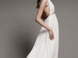 a Grecian A-line wedding dress with a halter neckline, an open back and detailing on the bodice and waist