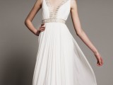 a flowy Grecian A-line pleated wedding dress with no sleeves, a deep V-neckline, detailing on the bodice and neckline