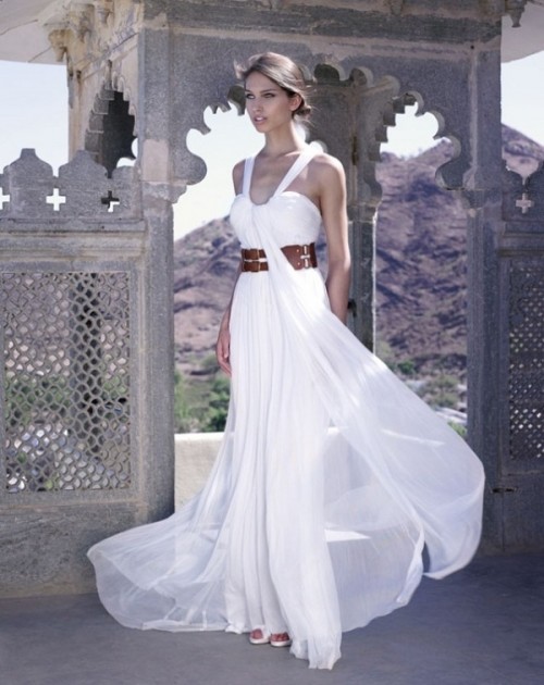 a pleated A-line wedding dress with a bandage bodice, thick straps, a brown leather belt and a pleated skirt