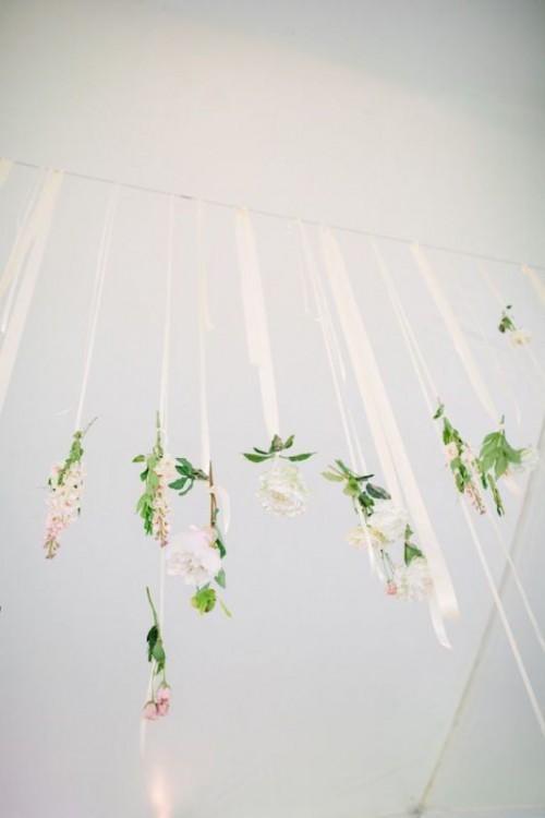 some neutral blooms hanging on ribbons will give your reception an ethereal and delicate look, perfect for spring or summer
