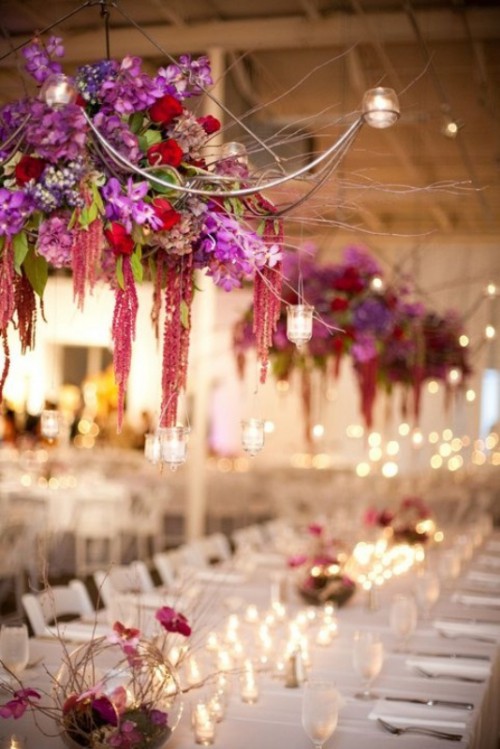 super lush colorful bloom chandeliers of pink, red, purple and green flowers and candle holders will spruce up any reception