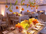some orange tulips plus refined crystal chandeliers hanging down from above look super cool and chic