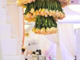 a fantastic floral chandelier of neutral tulips and pink roses on top is a chic and bold idea