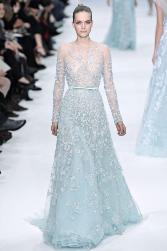 A jaw dropping fully embellished ice blue A line wedding dress with floral patterns, a high neckline and long sleeves just wows