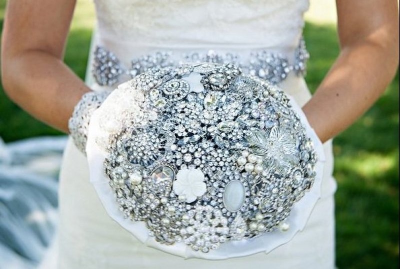 A silver and ice blue brooch wedding bouquet will be a gorgeous idea, match your embellished sash to it