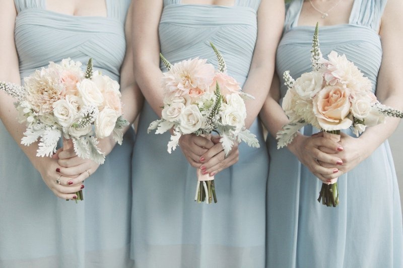 Ice blue bridesmaid dresses with thick straps and draped bodices for a frozen winter wedding