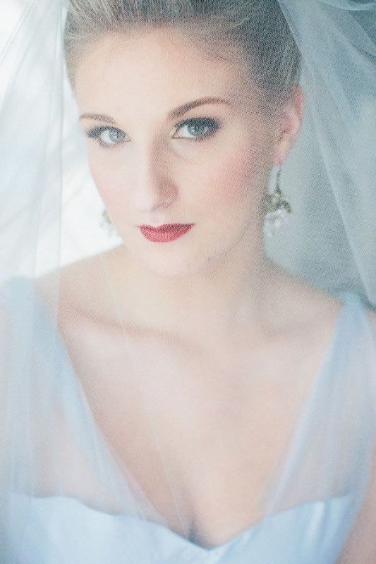 An ice blue wedding dress with a deep neckline and a matching veil for a frozen queen bridal look