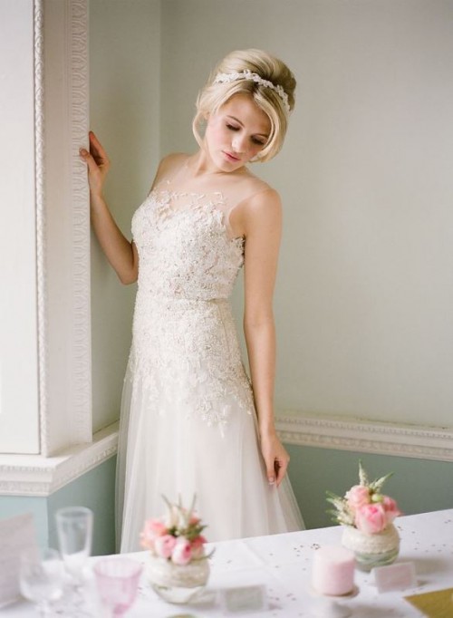 an A-line lace applique wedding dress with an illusion neckline and no sleeves is an ethereal and beautiful idea