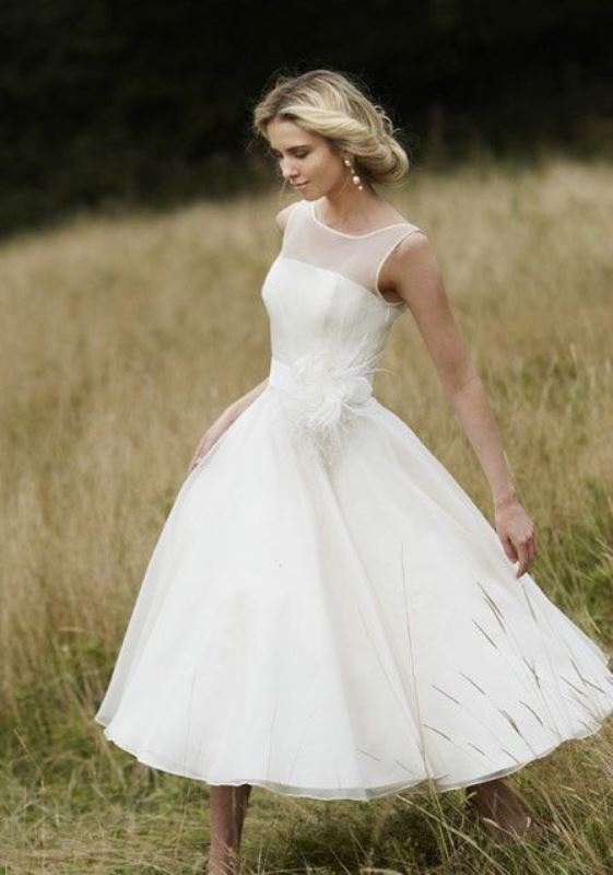 A retro inspired A line midi wedding dress with an illusion neckline and a sash is a cool and cute idea