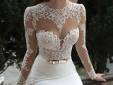 a sexy fitting wedding dress with an illusion neckline, long sleeves, a fitting skirt and a gold belt is a chic and lovely idea