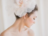 an oversized neutral fabric bow is a creative alternative to a usual bridal veil, and it will add a romantic touch to the look
