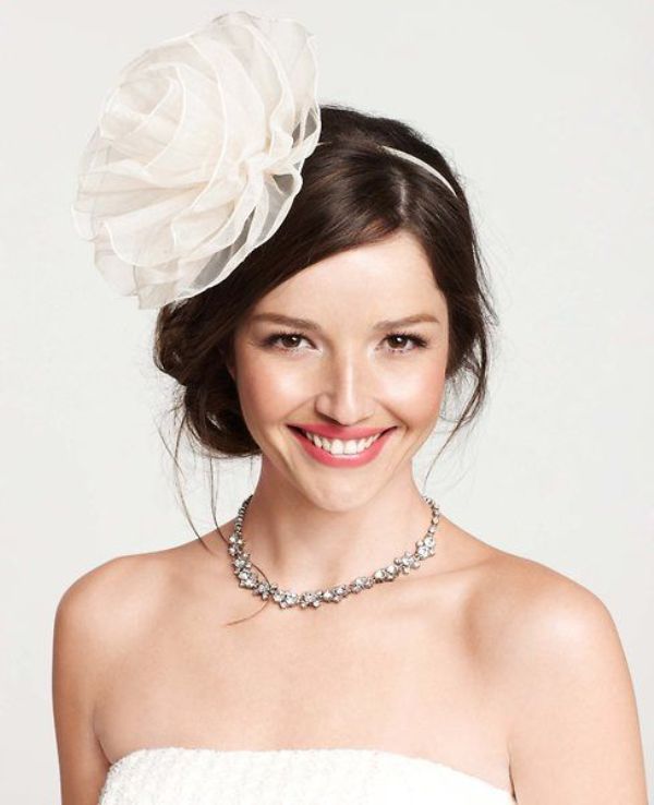 an oversized and statement white fabric flower headpiece is a chic and beautiful idea for a chic and stylish look, it can add elegance to your outfit