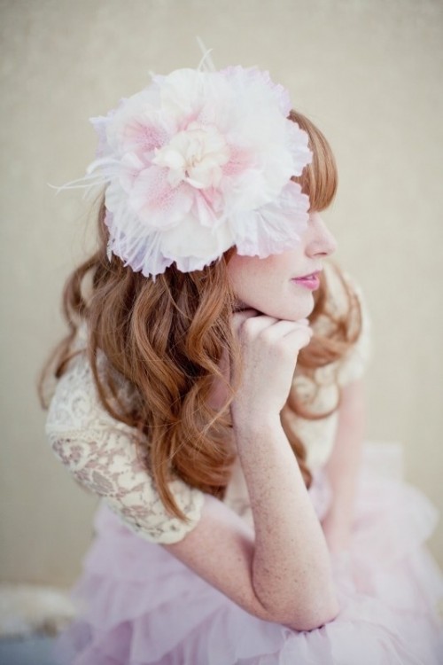 an oversized pink and neutral fabric bloom headpiece is a unique solution for a vintage-loving bride, it will make you stand out