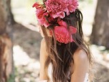 an oversized floral crown with large pink and deep red blooms is a sumptuous idea for a summer or fall wedding